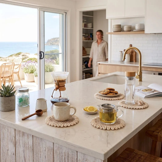 Kitchen counter with coffee and tea-making items, person in the background