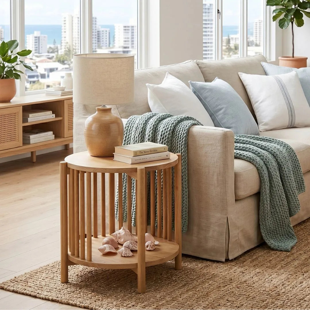Cozy living room with a beige sofa, wooden side table, and decorative items.