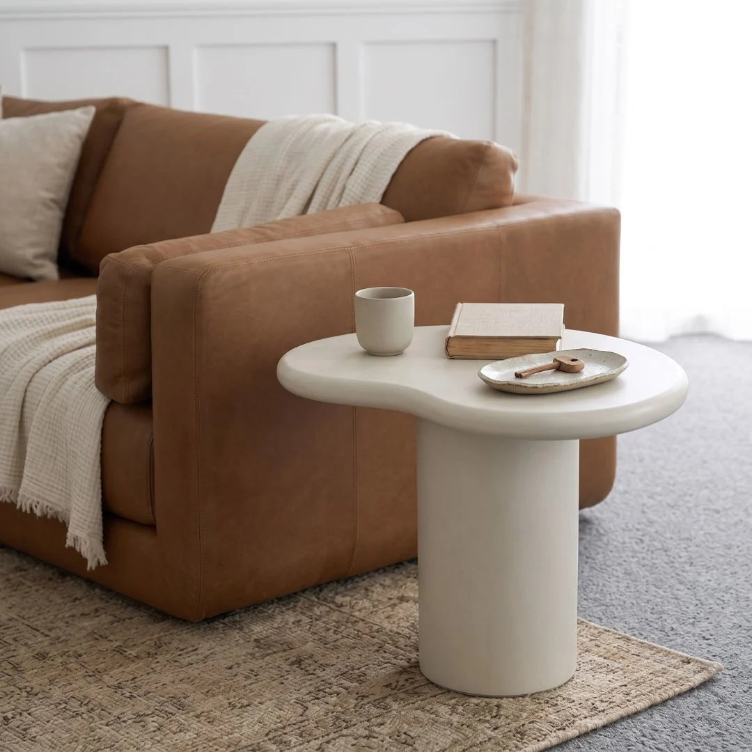 Siena microcement side table next to a sofa in a modern living room