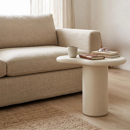 Siena microcement side table next to a sofa in a modern living room