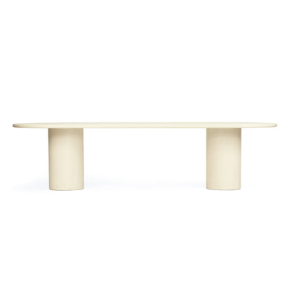 A minimalist modern table with a long oval top and two thick cylindrical pedestal legs, shown on a solid white background.