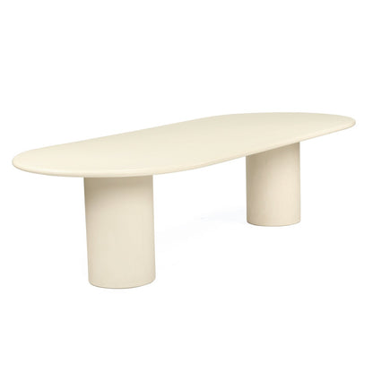 A minimalist oval coffee table with a smooth, rounded top and two cylindrical pedestal legs, finished in a warm cream or off-white color, shown on a solid white background.