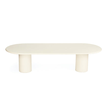 A minimalist  table with a rounded rectangular top and two cylindrical legs, finished in a warm off-white/cream color, shown on a solid white background.
