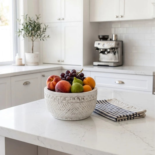 Fruit bowl on a kitchen counter with a coffee machine in the background