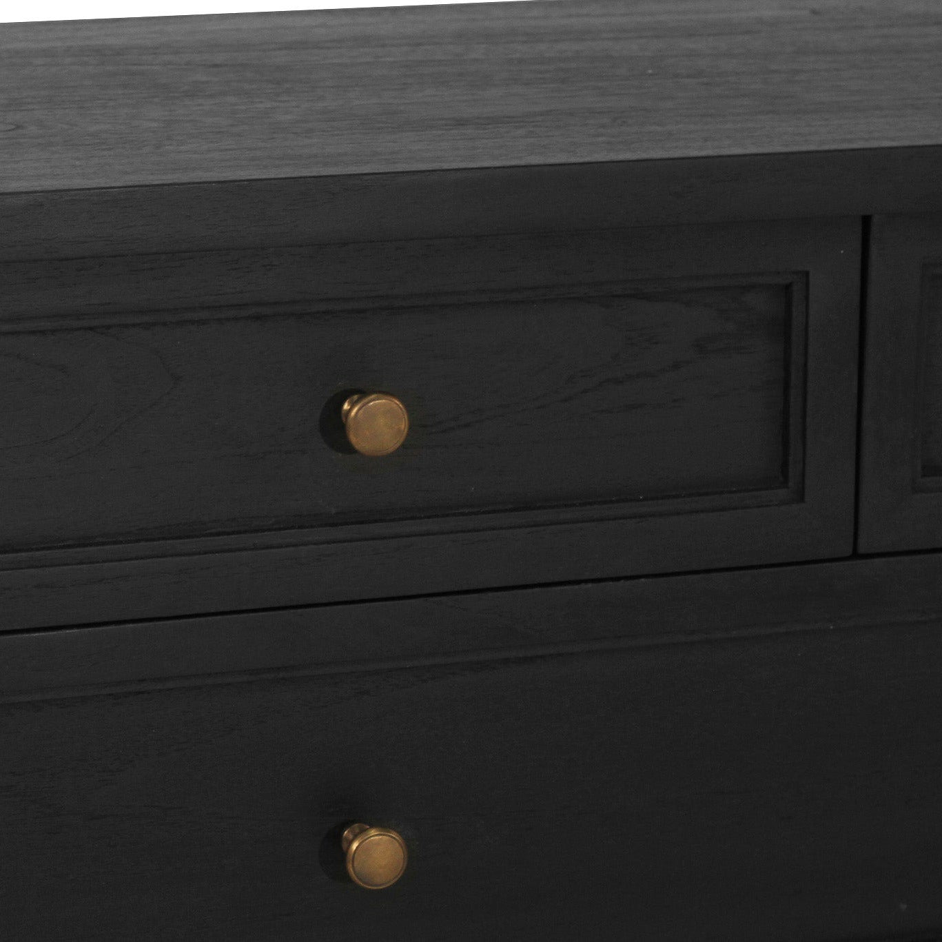 Black wooden dresser with gold knobs on a dark background