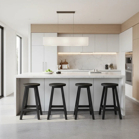 Round black teak stools at a kitchen island bench in a modern kitchen