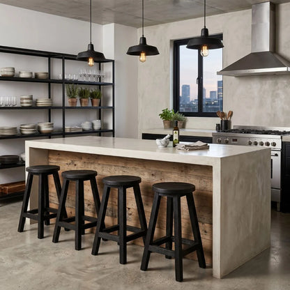Round black teak stools at a modern industrial kitchen island bench in apartment