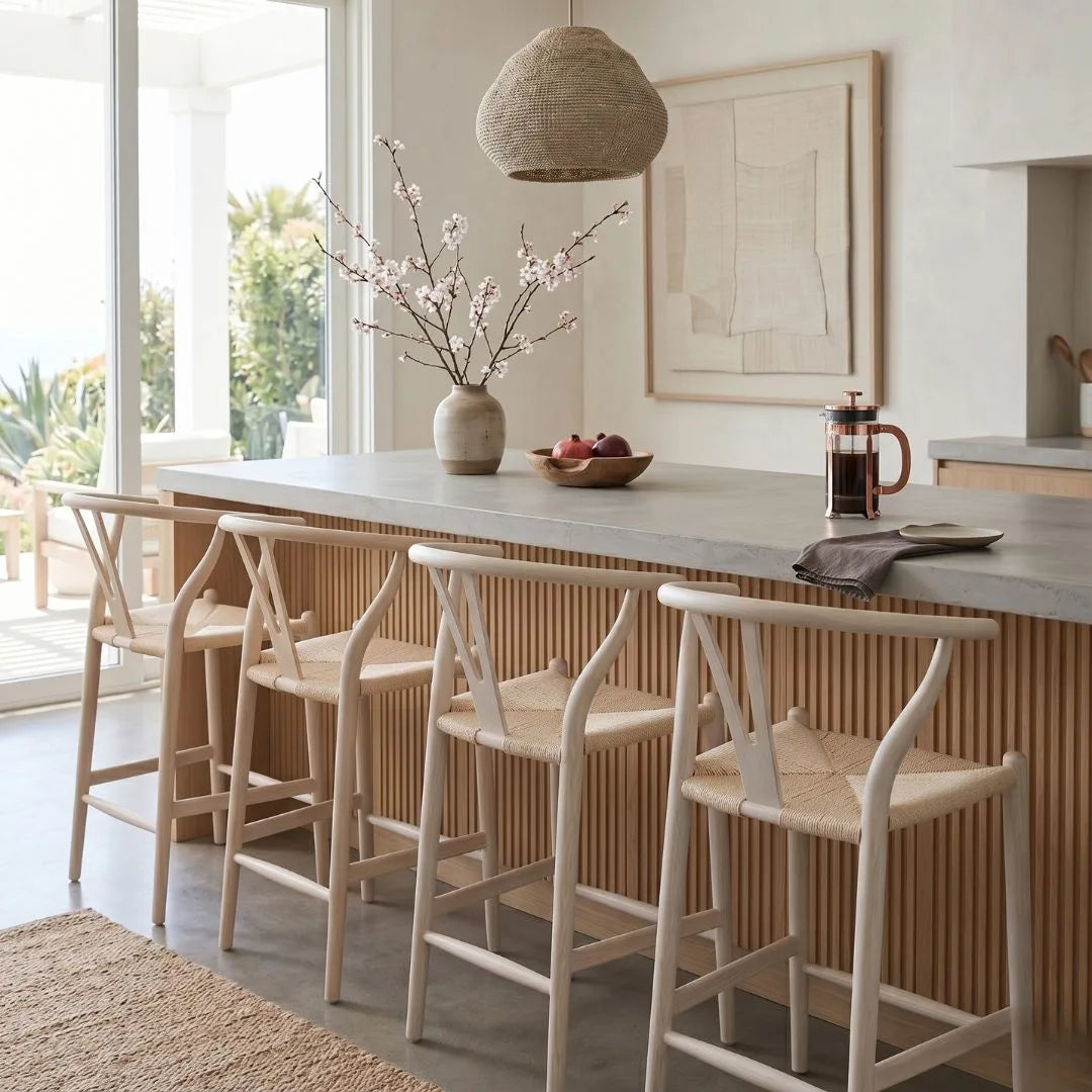 Modern kitchen with a breakfast bar, chairs, and decorative elements.