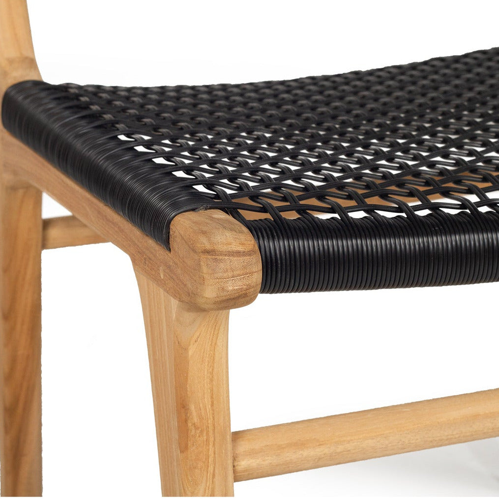 Close-up of a wooden chair with a black woven rope seat on a plain white background.