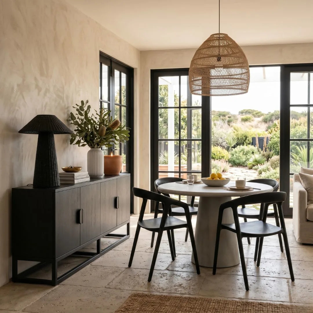 Modern dining room with a round table, chairs, and a large window.