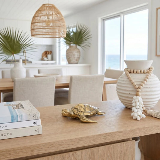 Dining room with a table, books, a turtle figurine, and decorative vase.