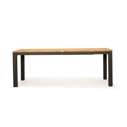 A rectangular table with a light natural wood top and a dark charcoal gray metal frame with four legs, shown against a plain white background.