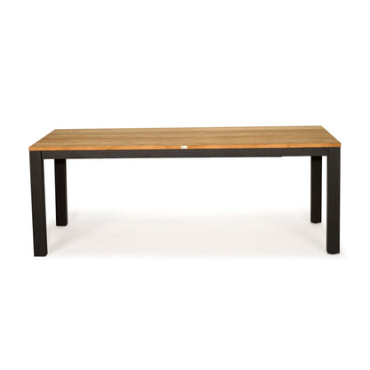 A rectangular wooden dining table with a light brown wood-grain top and a black metal frame with four legs, shown against a plain white background.