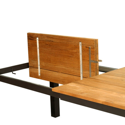 A modern industrial folding table with a light brown wood grain top and a black steel frame, shown partially extended on a white background.