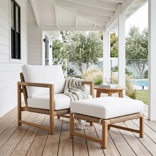 Outdoor furniture set with white cushions on a wooden deck.