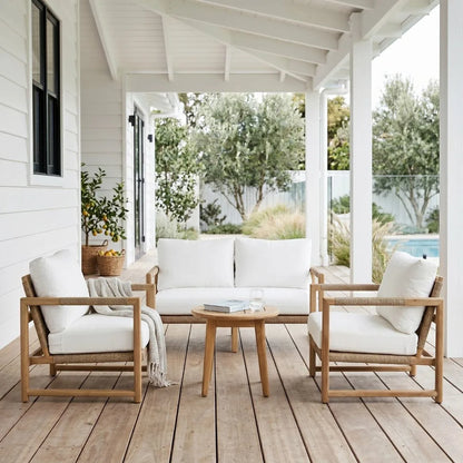 Outdoor patio set with wooden chairs and table on a wooden deck.