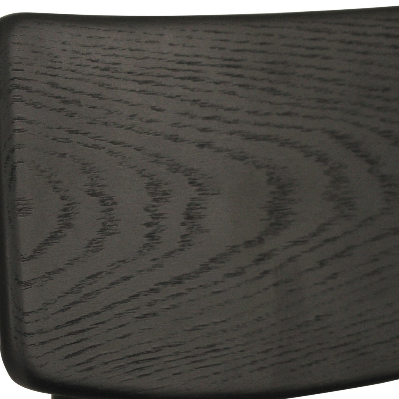 Close-up of a dark wood chair back showing the grain pattern and texture of a black or very dark brown finish.