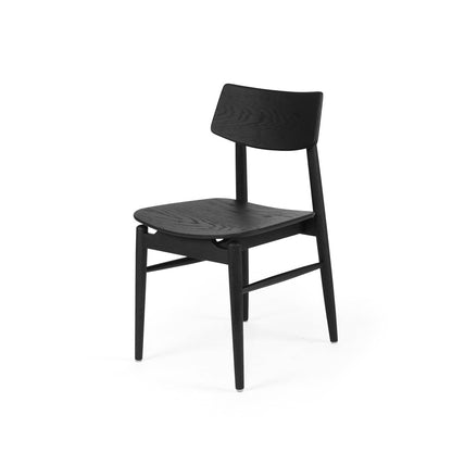 A minimalist black wooden dining chair with a slatted seat and backrest, shown from a three-quarters angle on a solid white background.