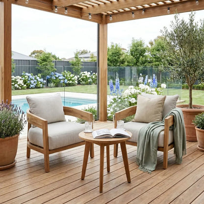 Outdoor patio with wooden chairs, table, and cushions on a wooden deck.