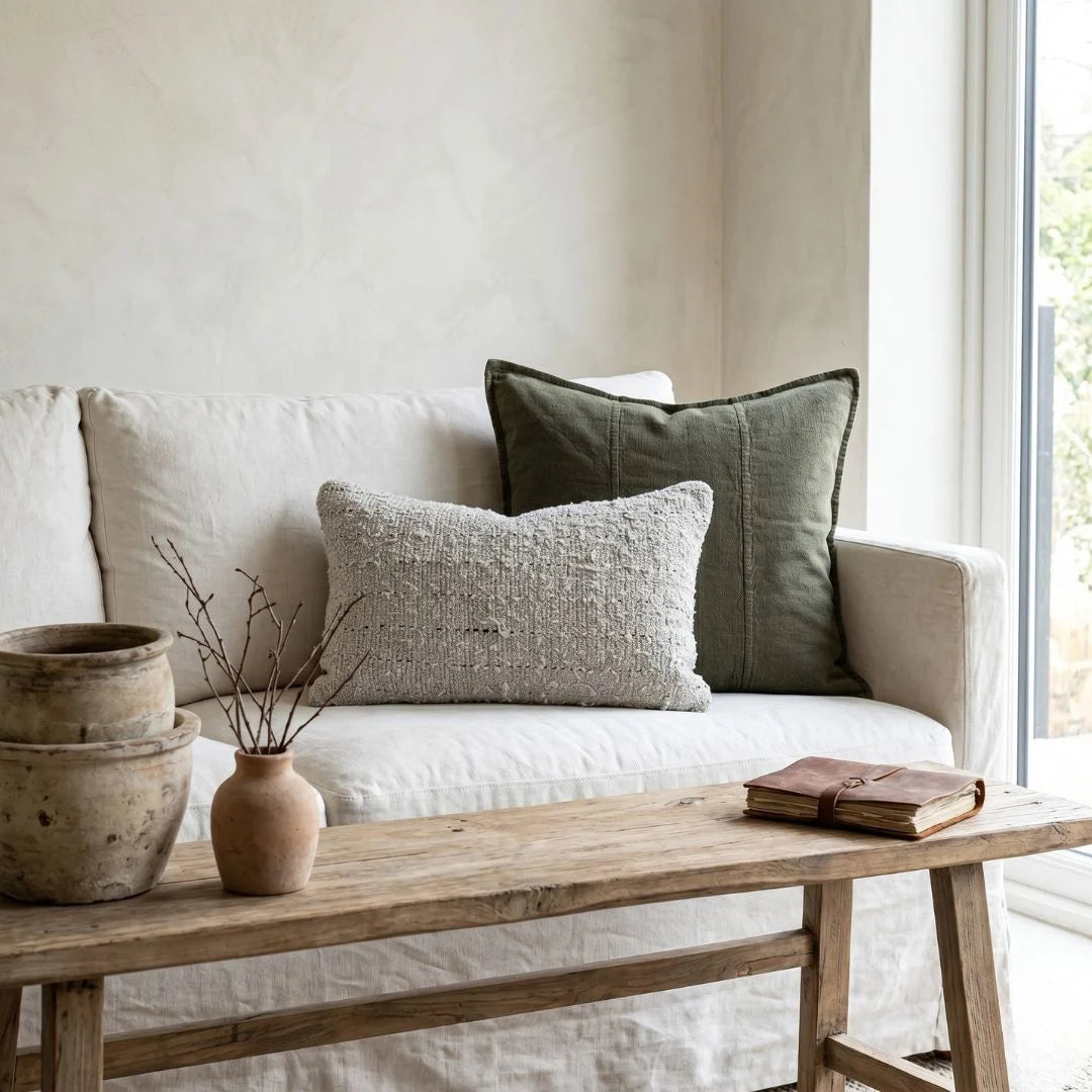 Beige sofa with textured cushions and a wooden coffee table in a bright room.