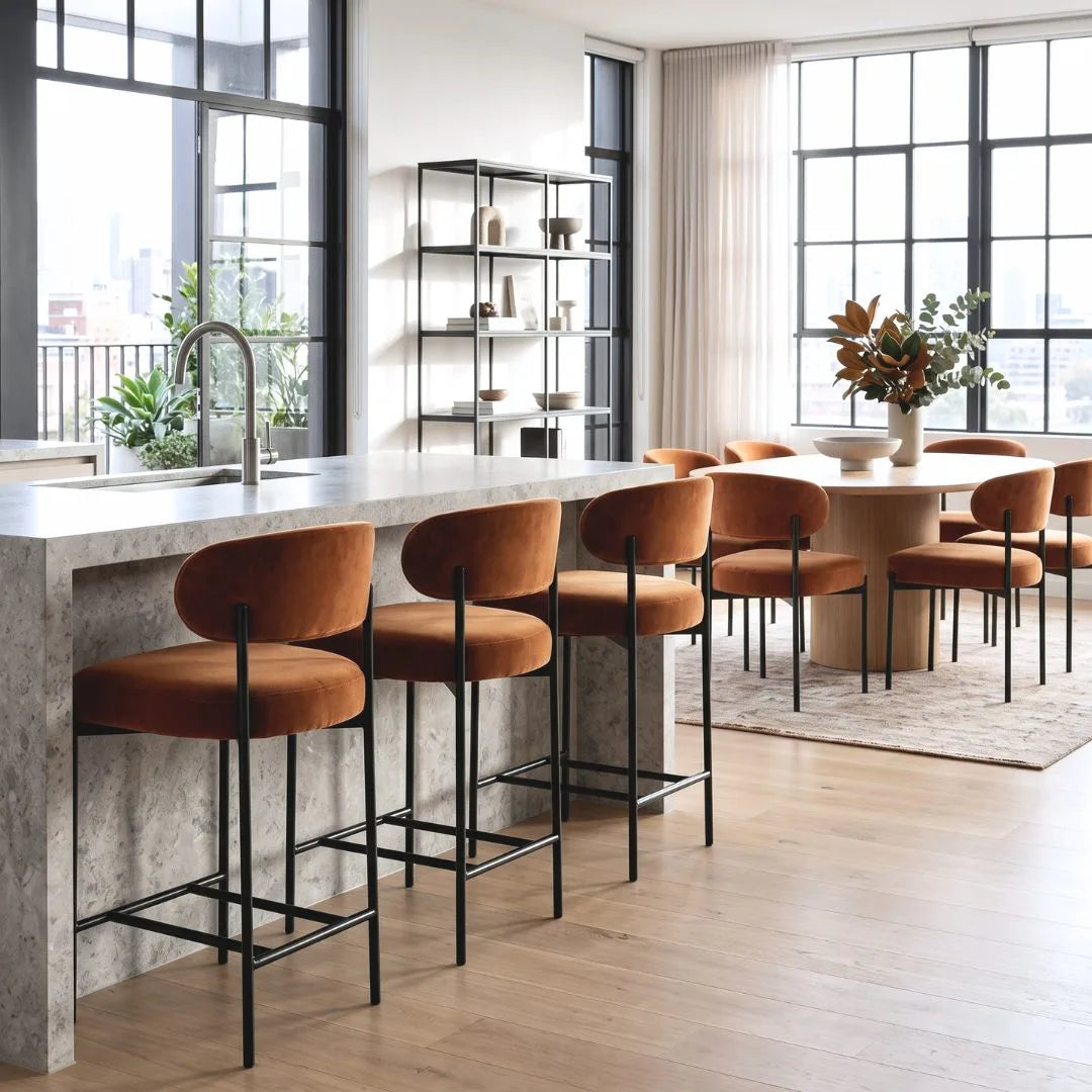 Modern kitchen with marble island and orange bar stools