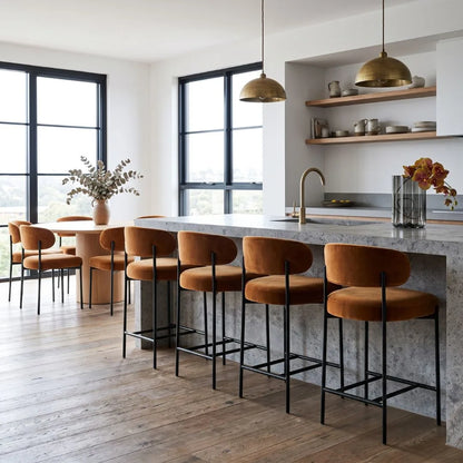 Modern kitchen with bar stools, a kitchen island, and pendant lights.