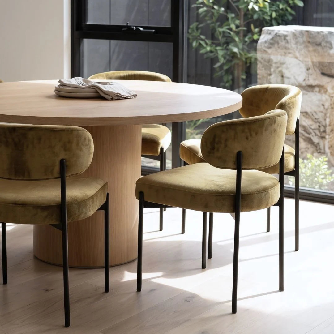 Dining table with beige chairs in a modern interior setting