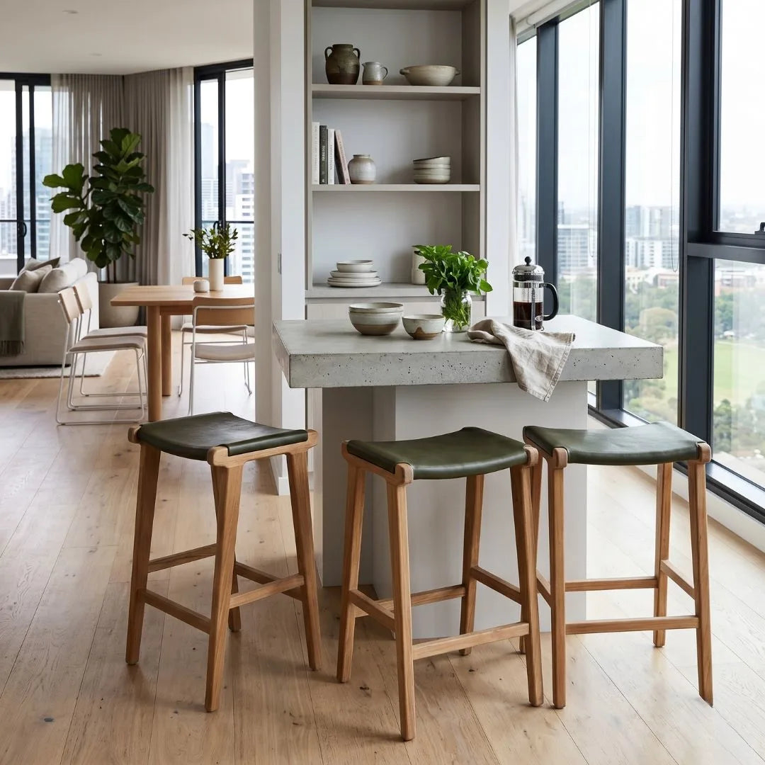 Sun Republic Olive leather and teak counter stools at a kitchen island bench in a modern apartment