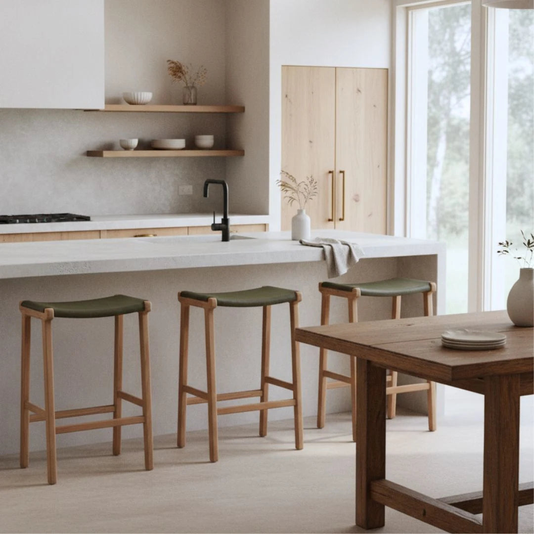 Sun Republic Olive leather and teak counter stools at a kitchen island bench in a modern kitchen