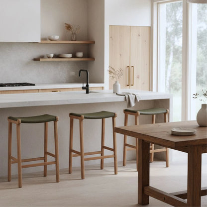 Sun Republic Olive leather and teak counter stools at a kitchen island bench in a modern kitchen
