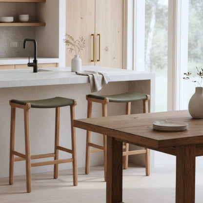 Sun Republic Olive leather and teak counter stools at a kitchen island bench in a modern kitchen