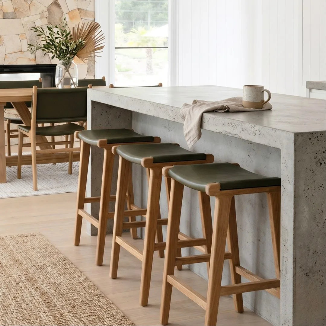 Sun Republic Olive leather and teak counter stools at a kitchen island bench in a modern kitchen