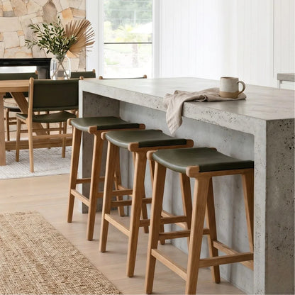 Sun Republic Olive leather and teak counter stools at a kitchen island bench in a modern kitchen