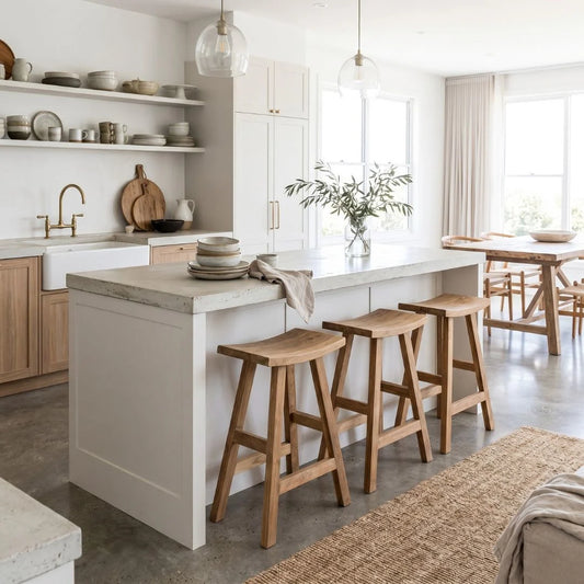 Sun Republic rustic teak counter stool in a row at a kitchen island bench in a modern light and bright kitchen