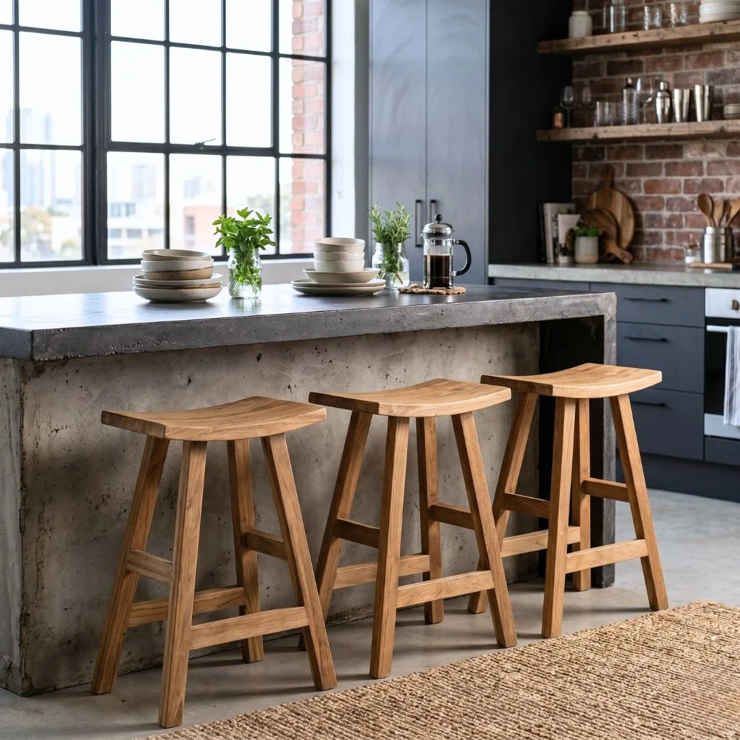 Sun Republic rustic teak counter stool in a row at a kitchen island bench in a modern industrial kitchen