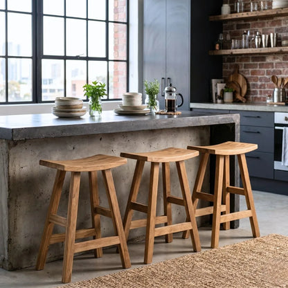 Sun Republic rustic teak counter stool in a row at a kitchen island bench in a modern industrial kitchen
