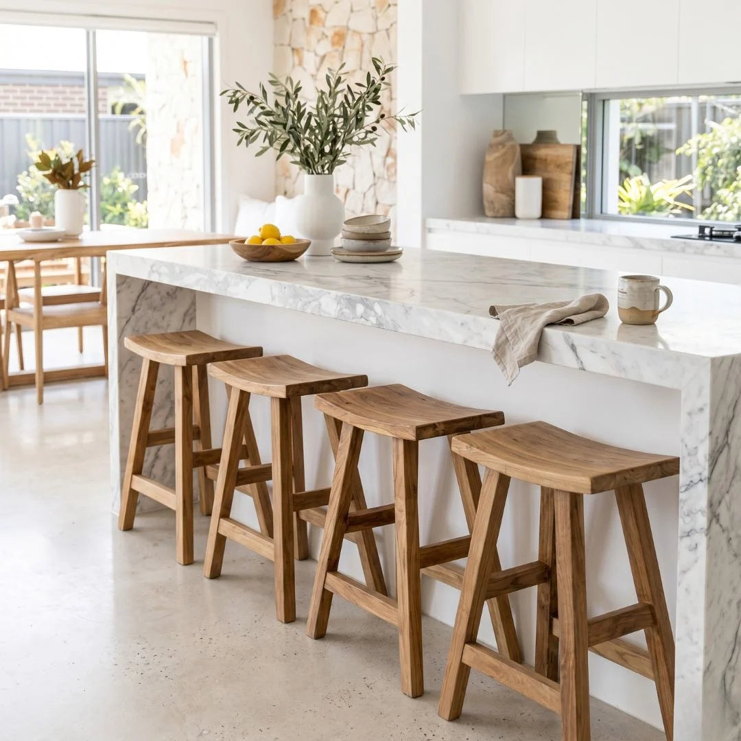 Sun Republic rustic teak counter stool in a row at a kitchen island bench in a modern light and bright kitchen