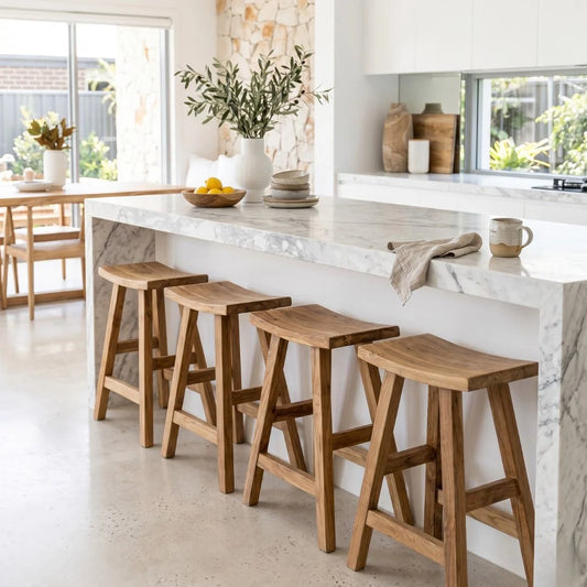 Sun Republic rustic teak counter stool in a row at a kitchen island bench in a modern light and bright kitchen