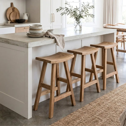 Sun Republic rustic teak counter stool in a row at a kitchen island bench in a modern light and bright kitchen