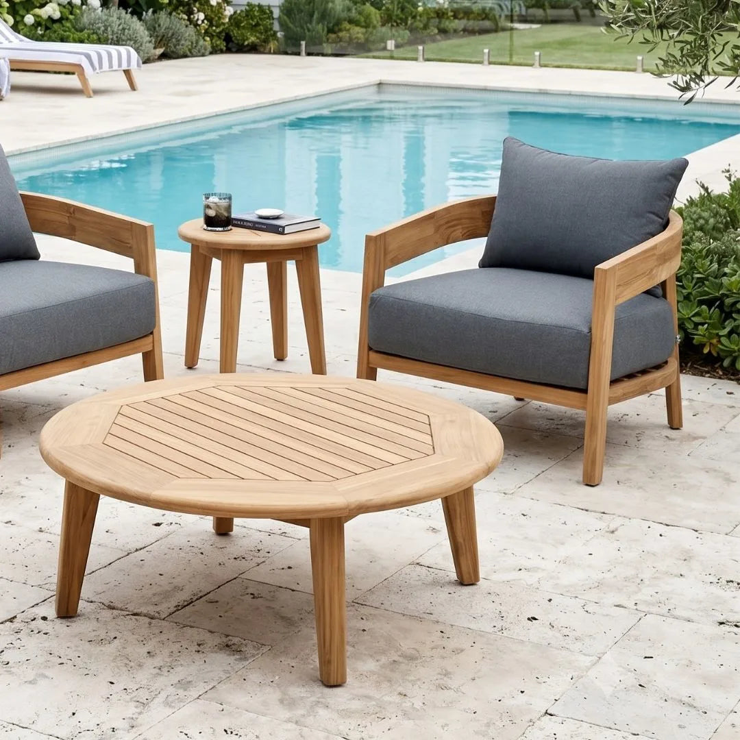 Outdoor furniture set with wooden chairs and table by a pool