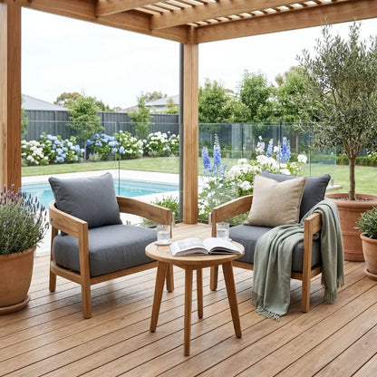 Outdoor patio with wooden chairs, table, and plants on a wooden deck.