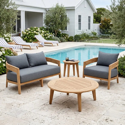Outdoor patio set with wooden chairs and table by a pool