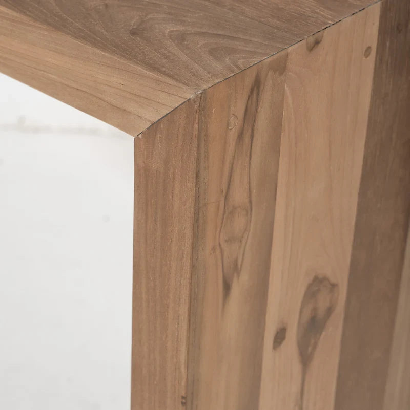 Close-up detail of a wooden furniture corner showing natural wood grain, knots, and plank construction.