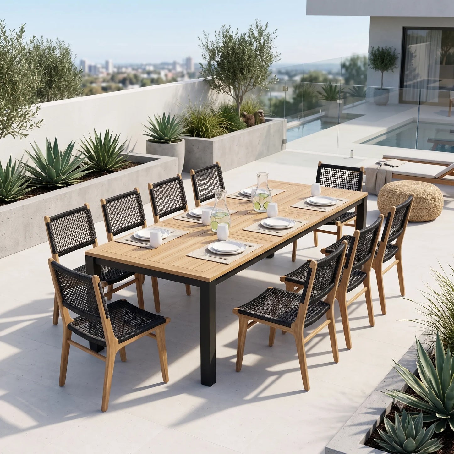 An outdoor dining set on a rooftop terrace, featuring a rectangular wooden table with black metal legs and eight matching chairs with black woven seats and wooden frames. The set is styled with tableware, including plates, glasses, and a water pitcher, set against a backdrop of a pool, city skyline, and green plants.