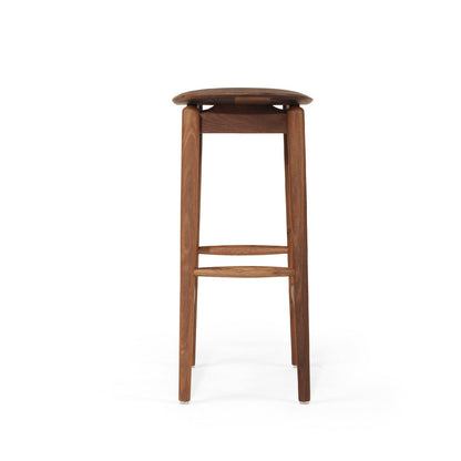A single wooden bar stool with a dark brown seat and legs, featuring a footrest, photographed against a seamless white background.