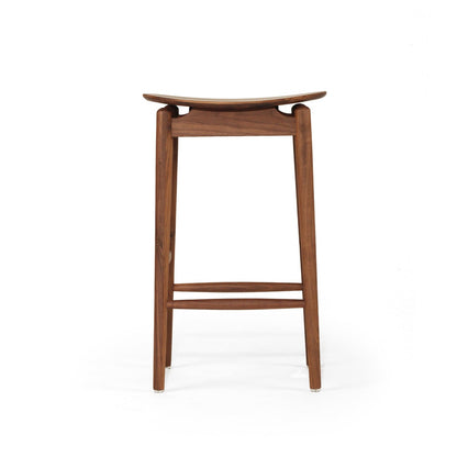 A mid-century modern wooden stool with a curved seat, four legs, and a footrest, shown from the front on a white background.