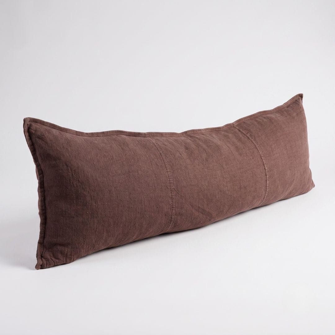 A long, rectangular lumbar pillow in a textured brown linen fabric, photographed on a clean white studio background.