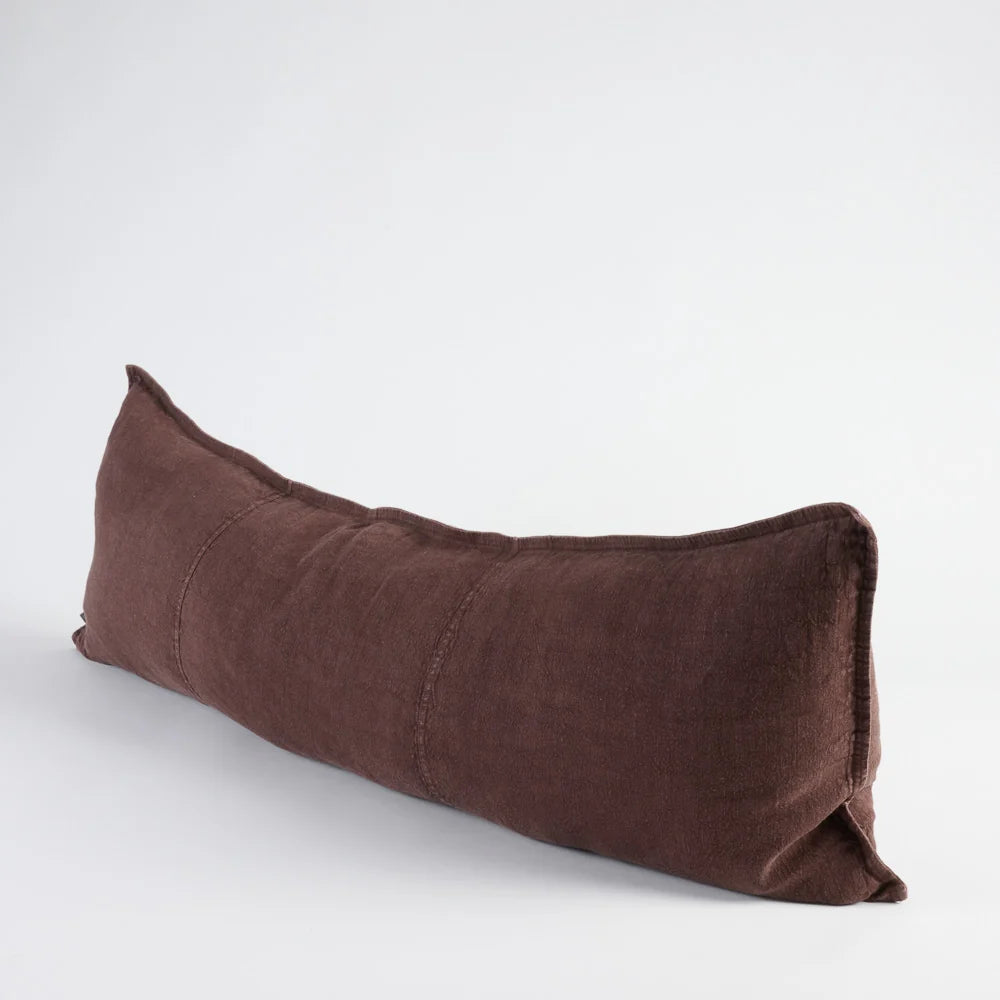 A long, rectangular lumbar pillow in a dark brown linen fabric, photographed on a clean white studio background.