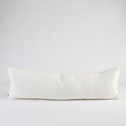 A long, rectangular lumbar pillow in off-white linen fabric, photographed against a seamless light gray studio background.