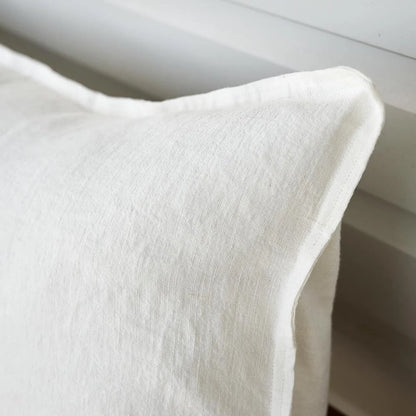 Close-up of a textured white pillow on a neutral background